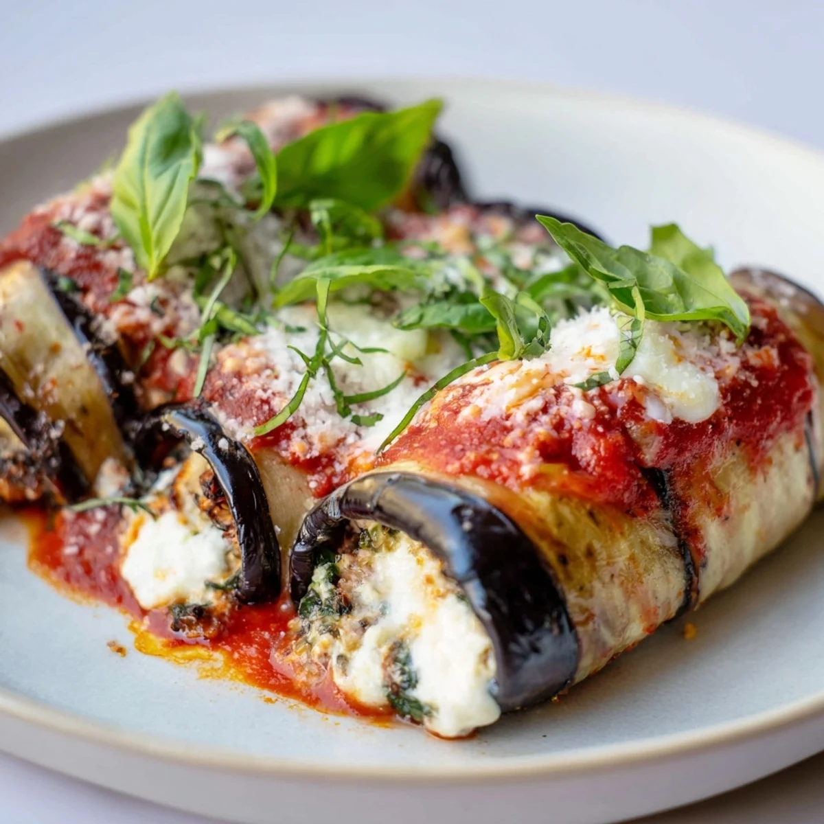 A baking dish overflowing with flavorful Baked Eggplant Rollatini, ready to serve and enjoy.