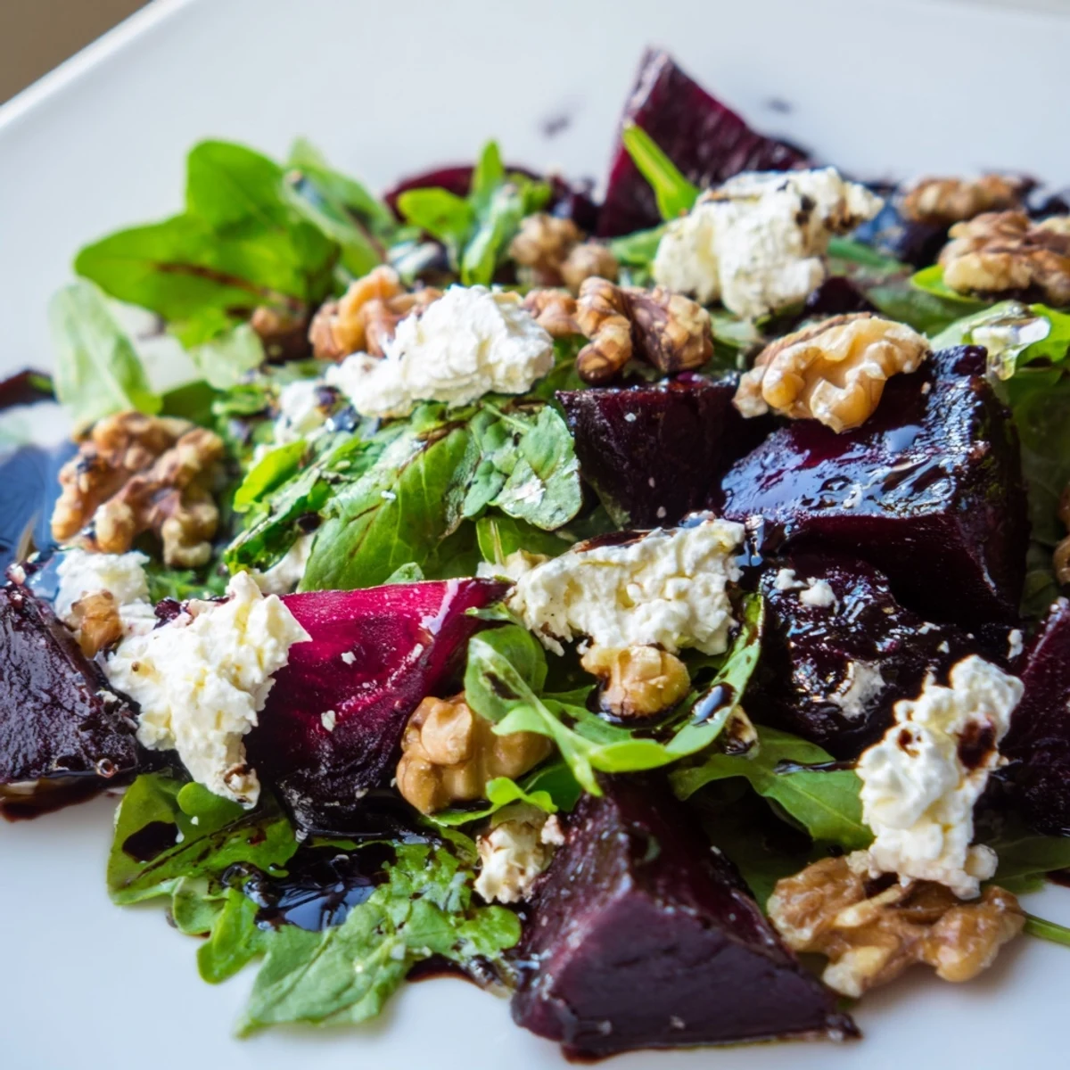 A platter of Roasted Beet and Feta Salad with Balsamic, featuring ruby-red beets and crumbled cheese.