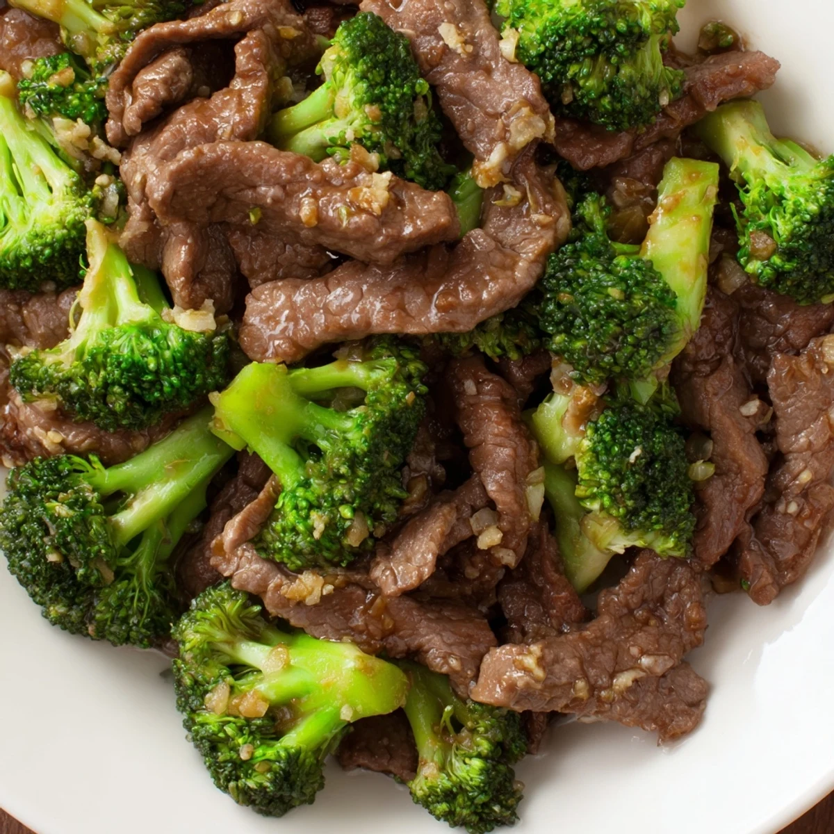Beef and Broccoli Stir Fry with Oyster Sauce plated family-style, ready to serve with chopsticks and fluffy white rice.