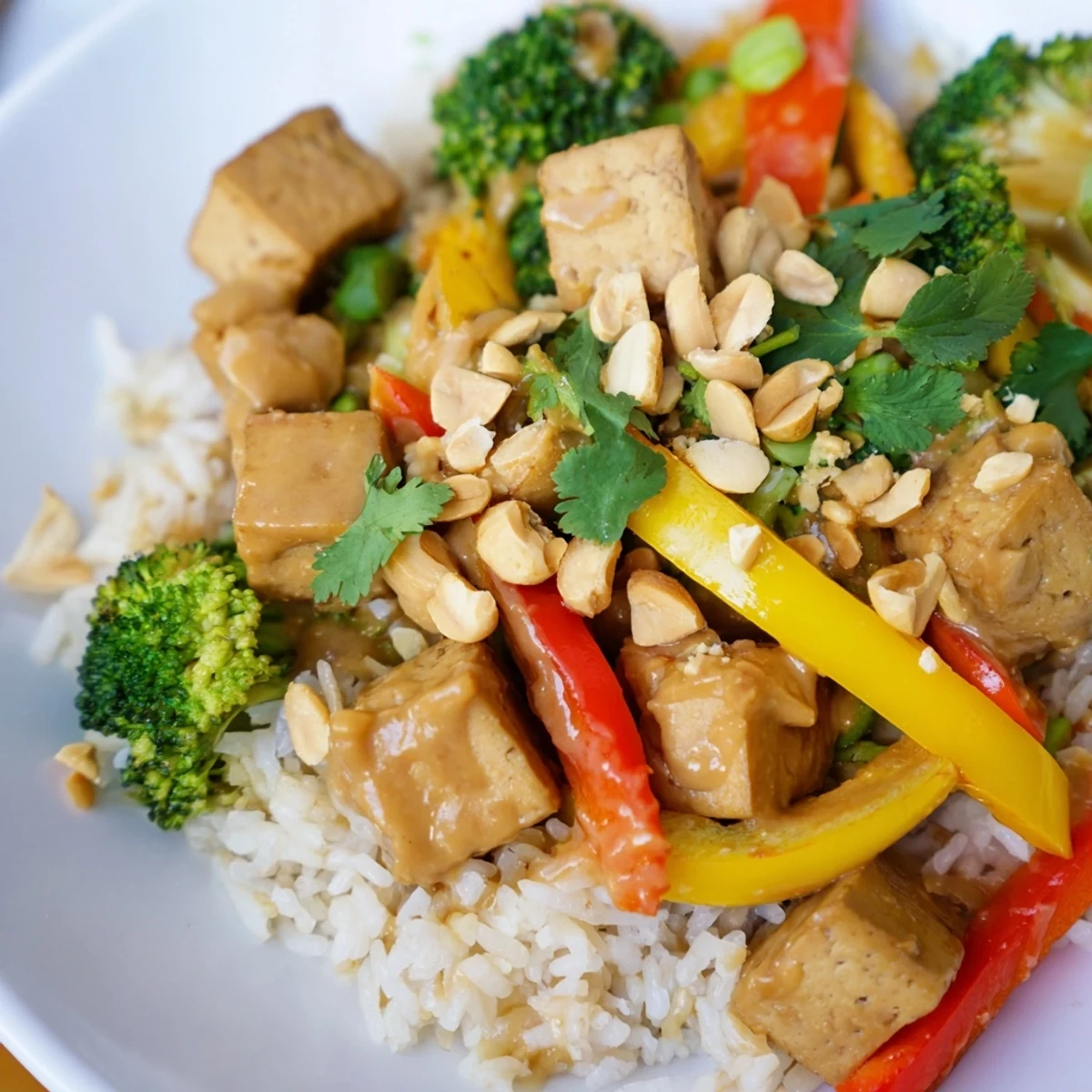 A close look at vegan Crispy Tofu Stir Fry with Peanut Sauce and crunchy chopped peanuts.