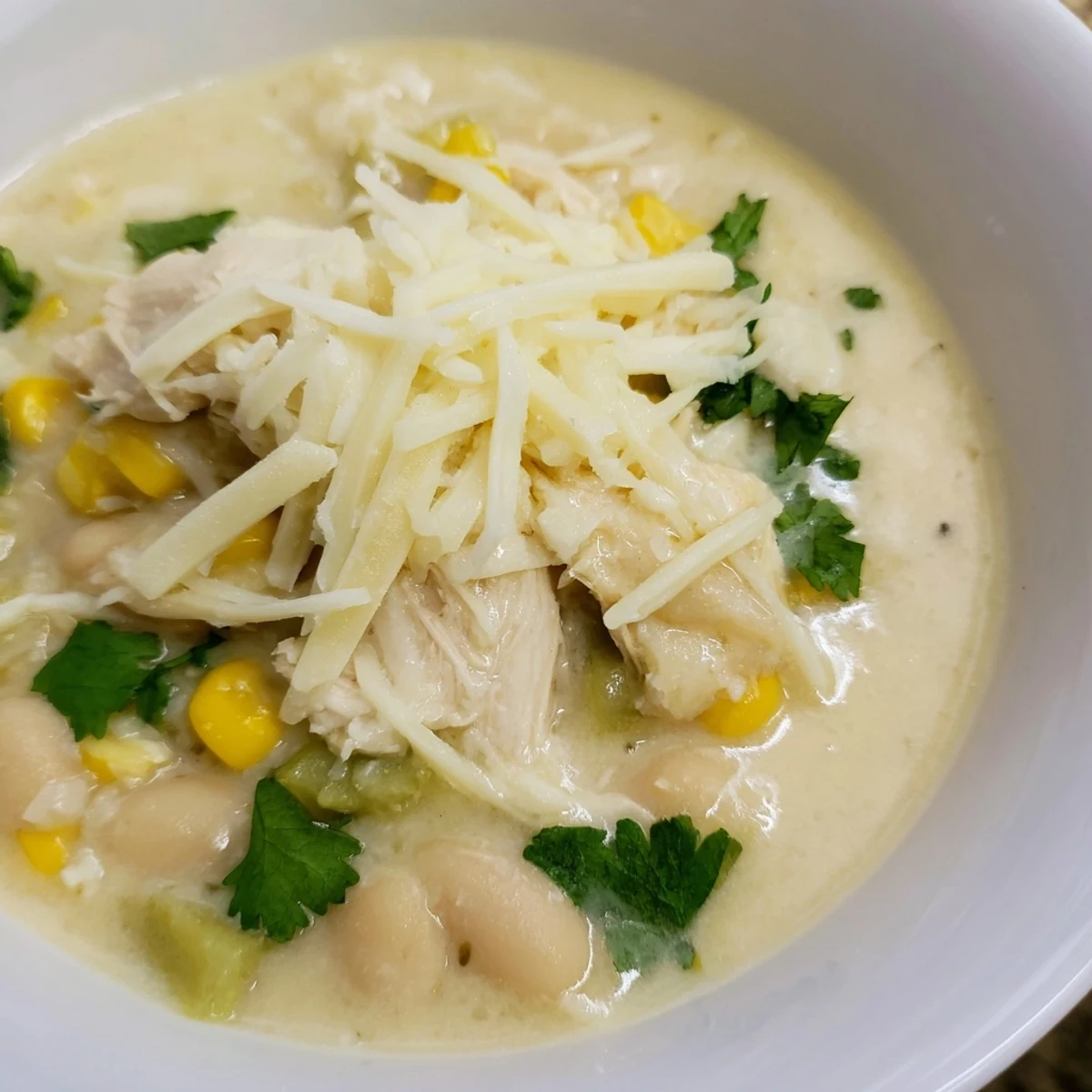Sizzling pot of White Chicken Chili featuring tender chicken, white beans, and sweet corn, ready to serve.