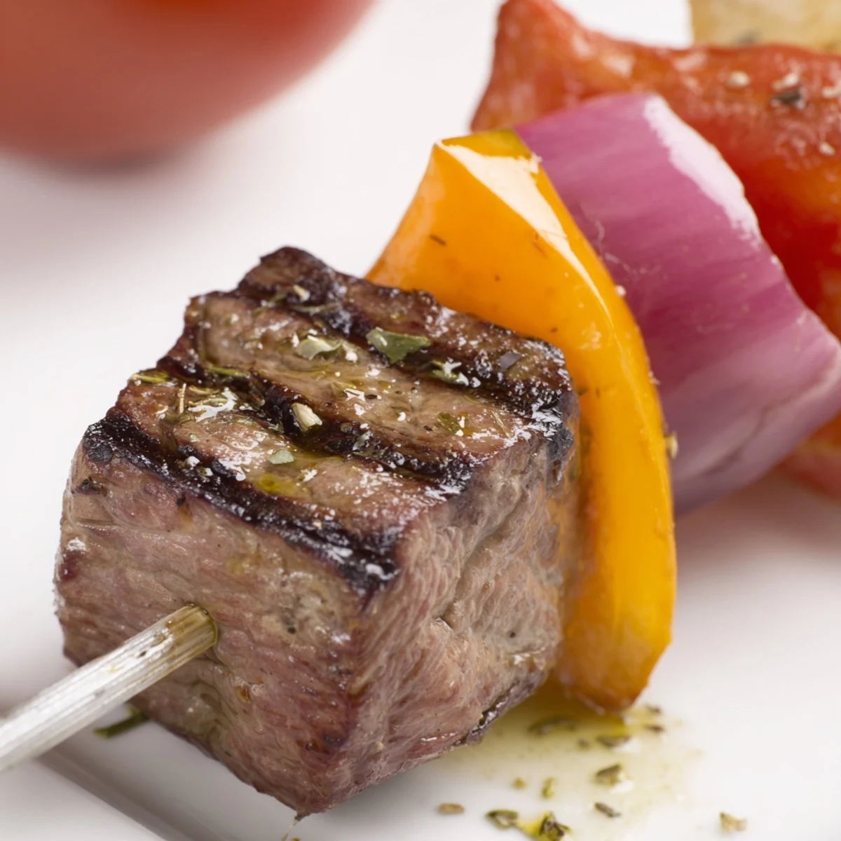 Skewers of tender Beef Kebabs with Bell Peppers and Red Onion, displaying vibrant red, yellow, and green vegetables alongside the beef.