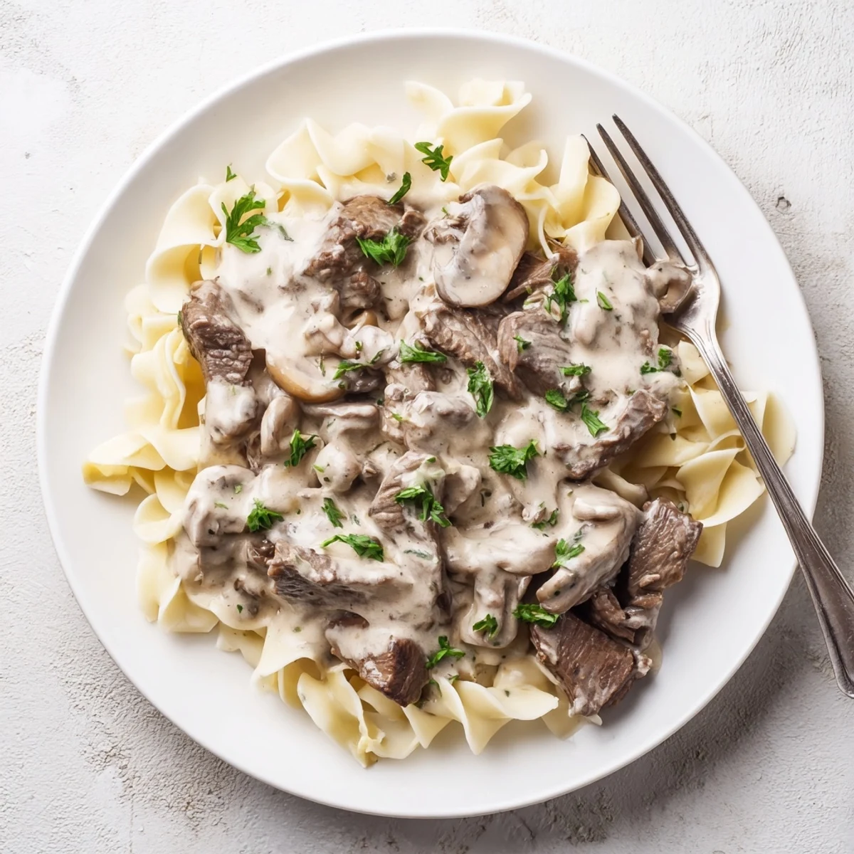 Tender beef strips and sautéed mushrooms in creamy sauce served over fluffy egg noodles.  