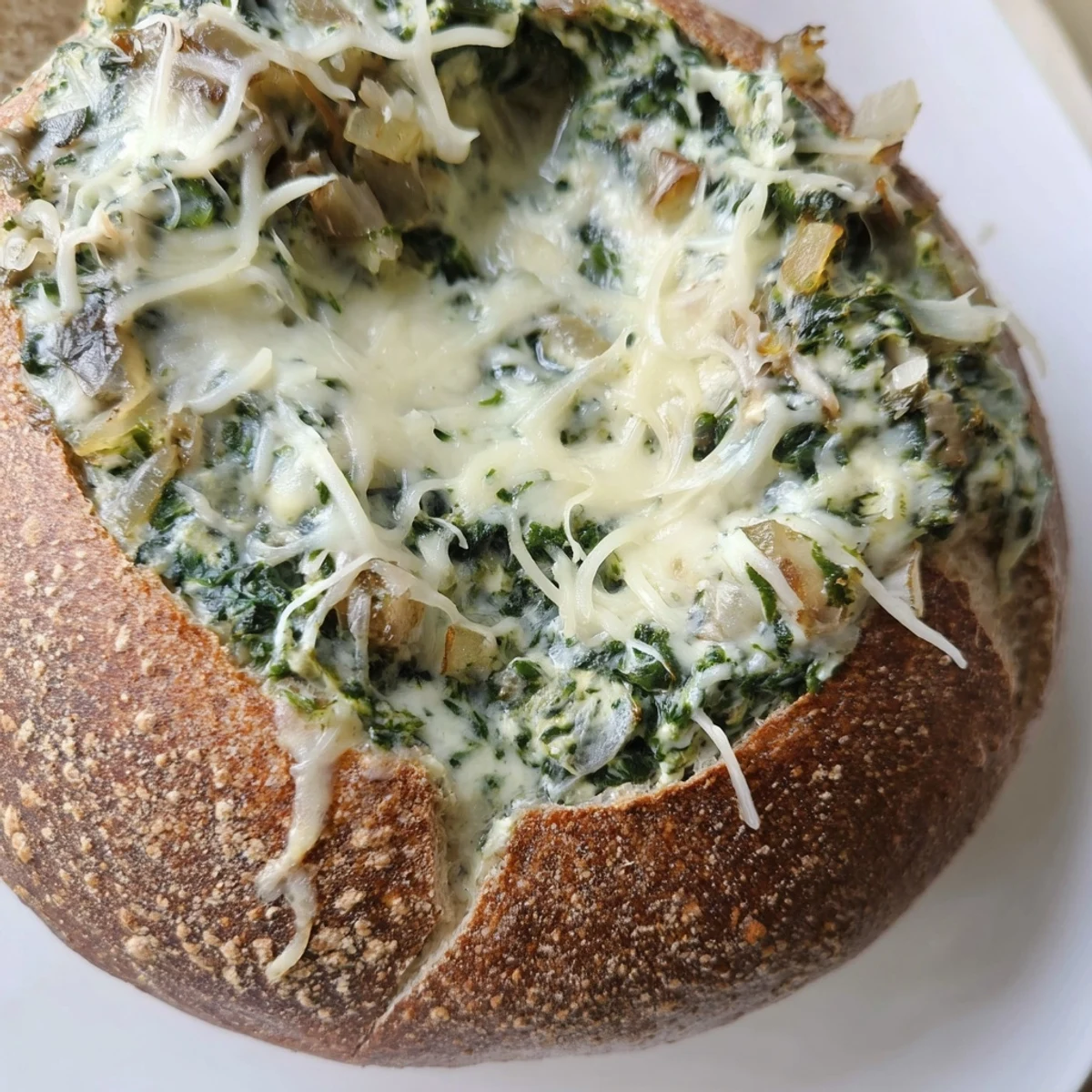 Warm Creamy Spinach Dip with Sourdough Bread in a bread bowl at a cozy gathering.
