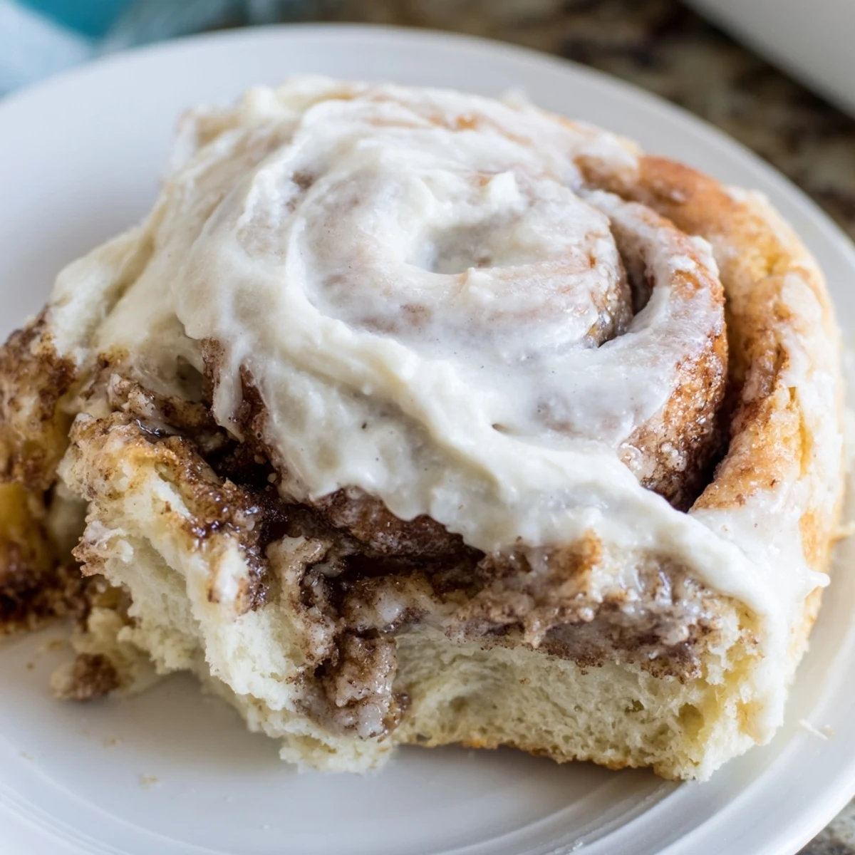 Overhead view of eight golden Keto Cinnamon Buns in a round baking pan, ready for breakfast.
