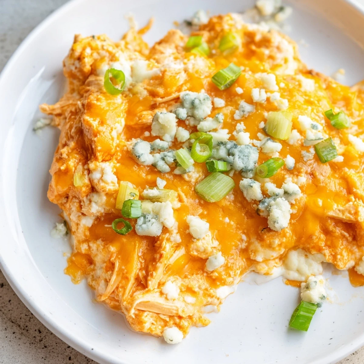 Keto Buffalo Chicken Dip served warm with celery sticks and a creamy buffalo sauce aroma.