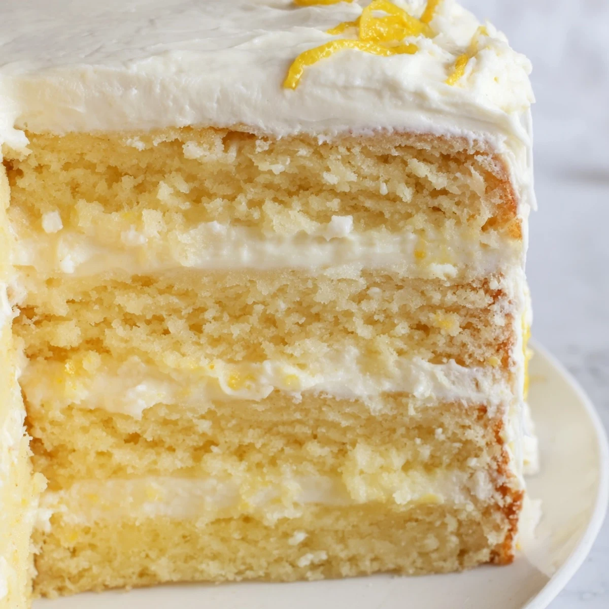 Limoncello Mascarpone Cake slices showcase tender crumb and rich cream, served chilled with lemon garnish on a rustic wooden board.