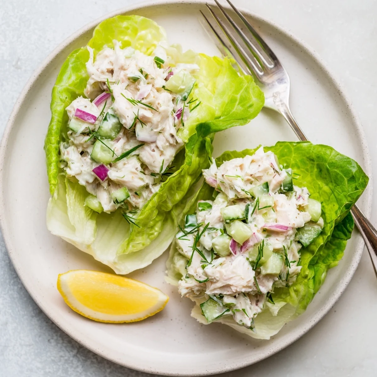 Crab salad featuring tender lump crab meat mixed with crisp celery and cucumber in a creamy dressing on butter lettuce.
