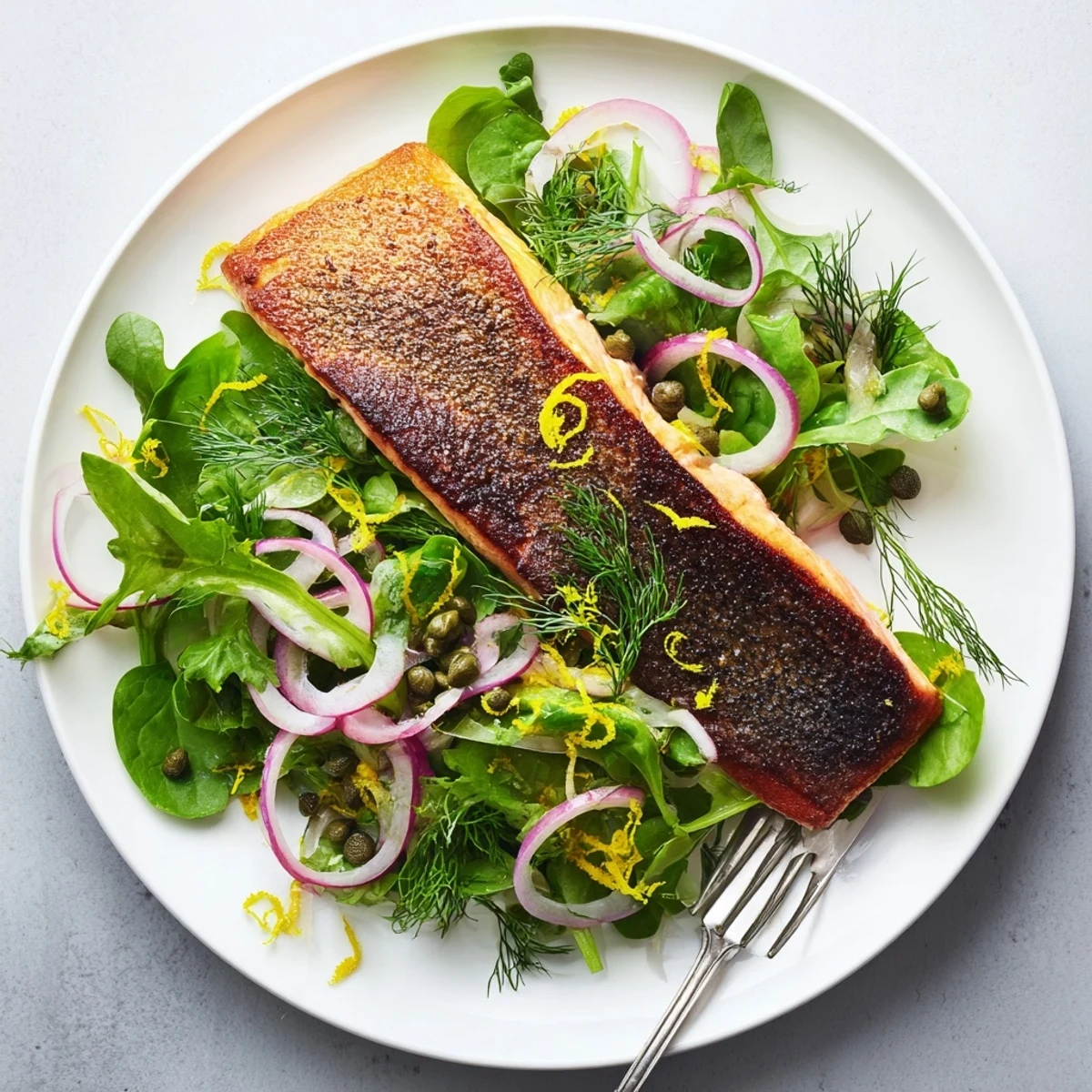 Lemon zest and capers brighten this easy Crispy Skin Tasmanian Atlantic Salmon dish served with a simple herb salad.