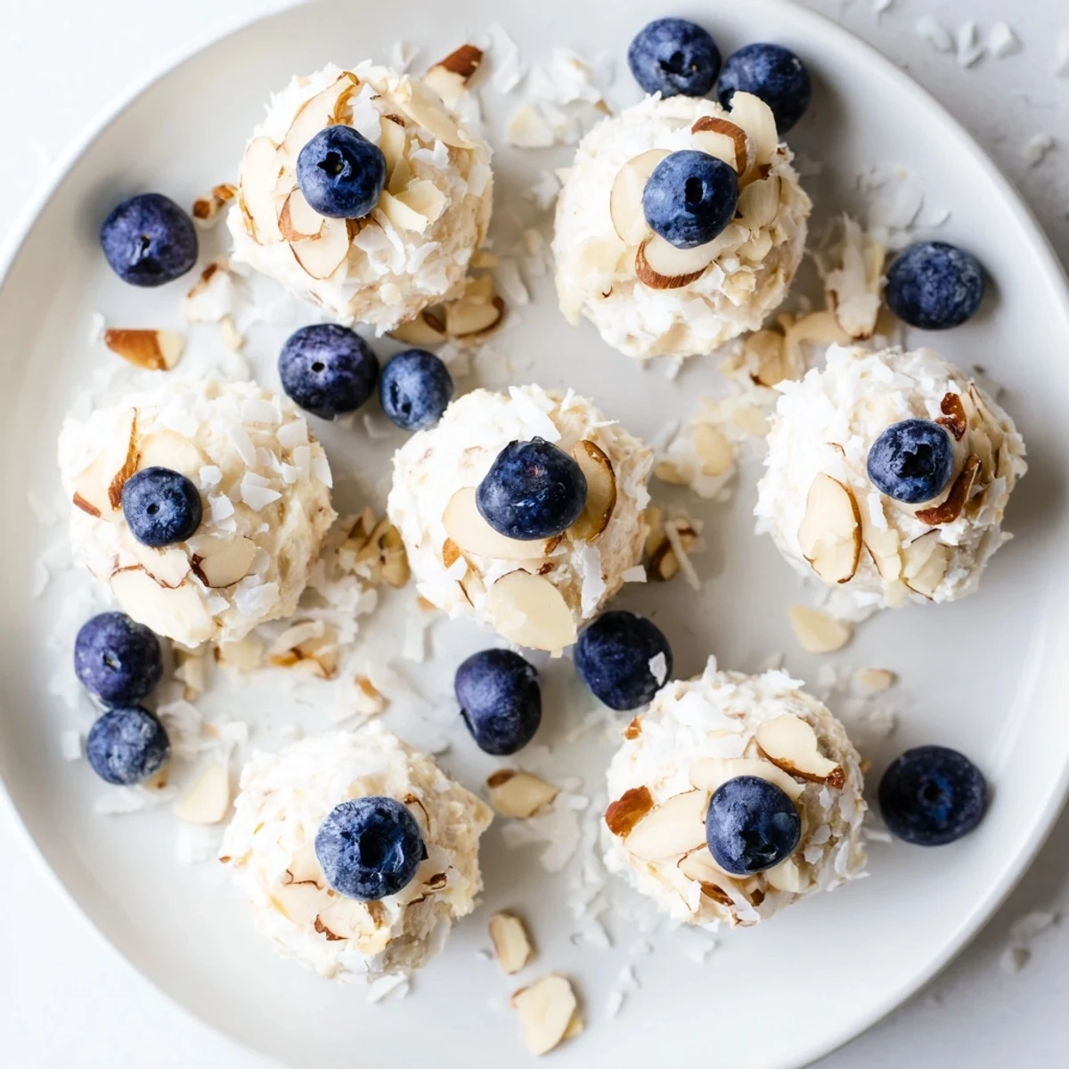White yogurt mounds topped with plump blueberries ready for freezing into healthy snack bites