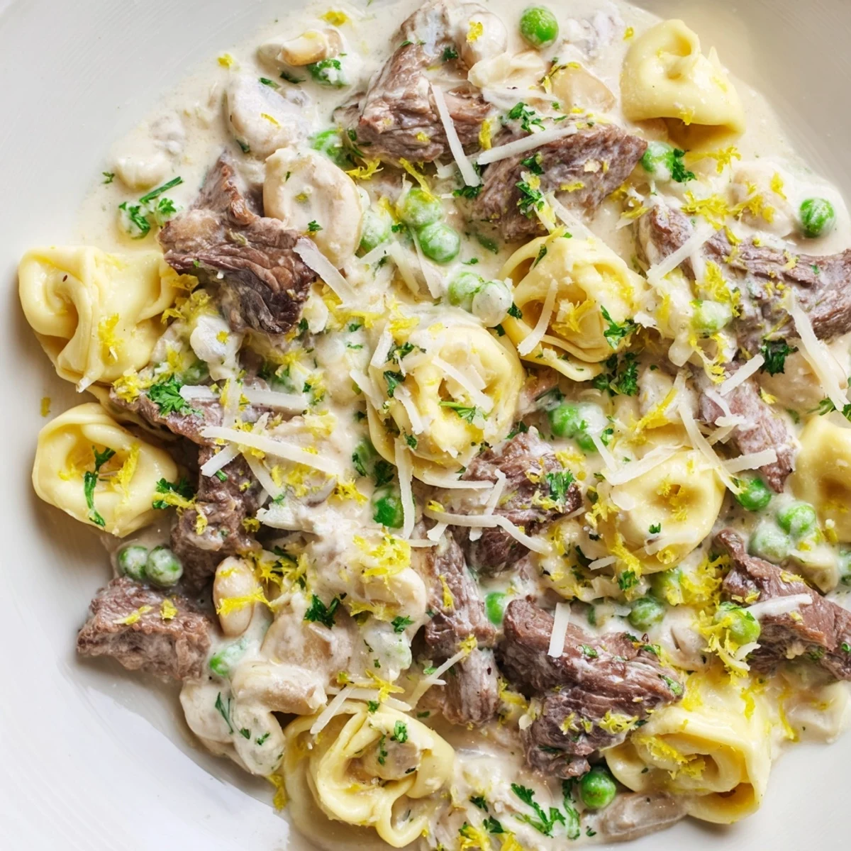 Decadent cracked garlic steak tortellini featuring tender beef bites in velvety white herb sauce