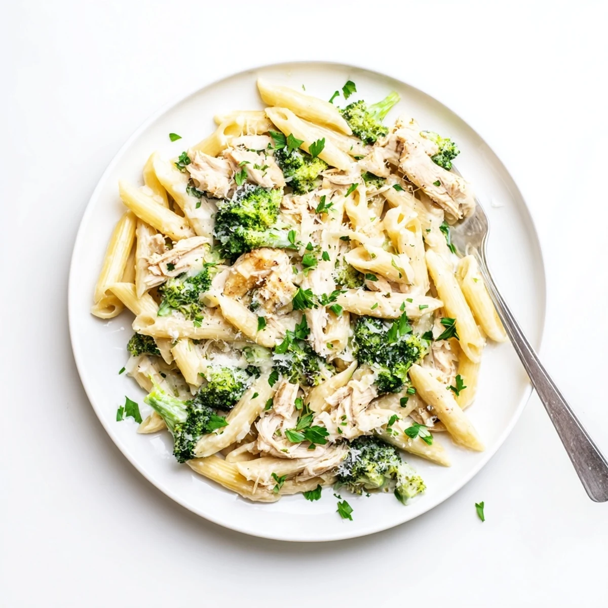 Steamy bowl of rotisserie chicken broccoli pasta featuring tender penne, shredded chicken, and vibrant green florets