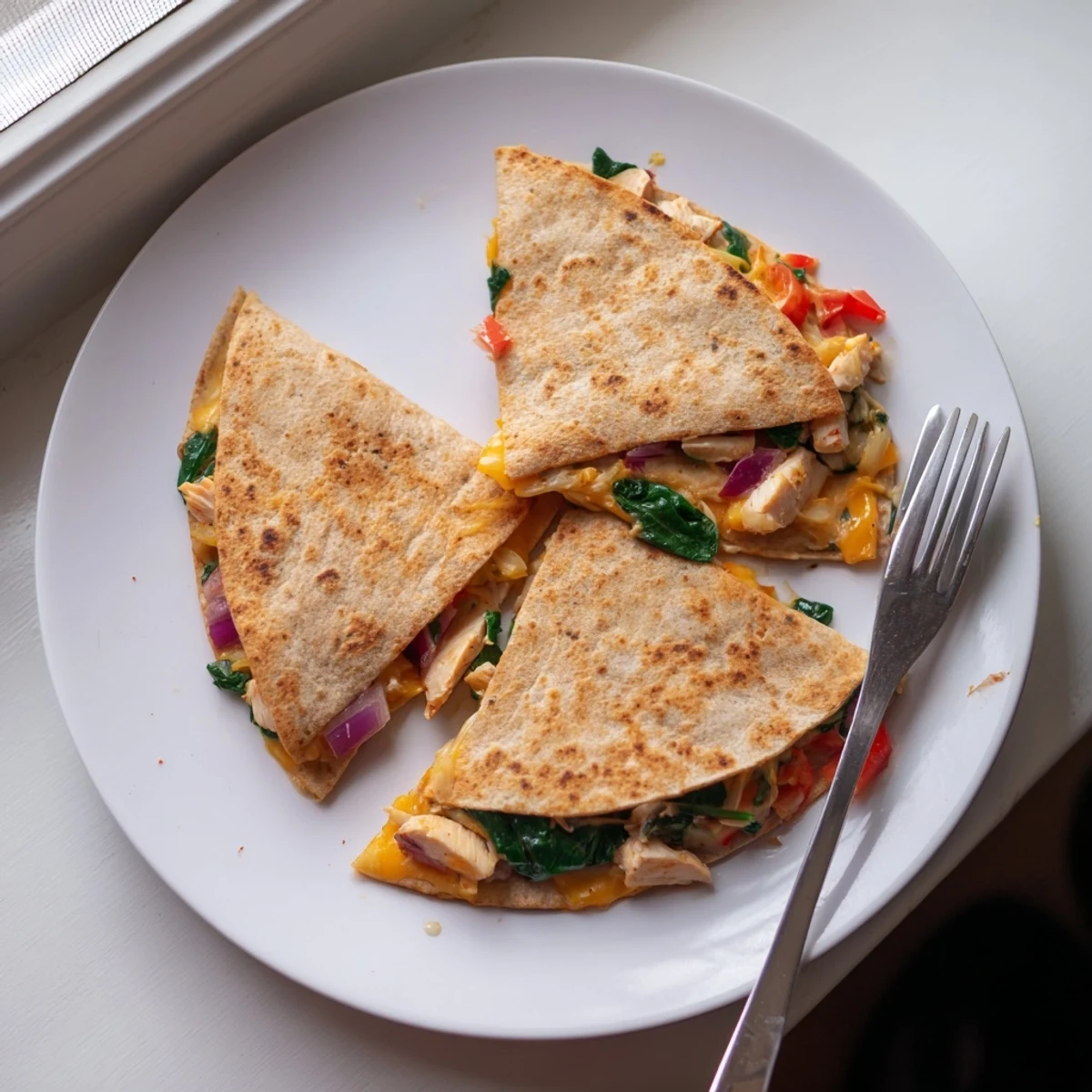 Crispy whole wheat tortilla stuffed with seasoned chicken, ranch drizzle, peppers, and spinach for a protein packed meal