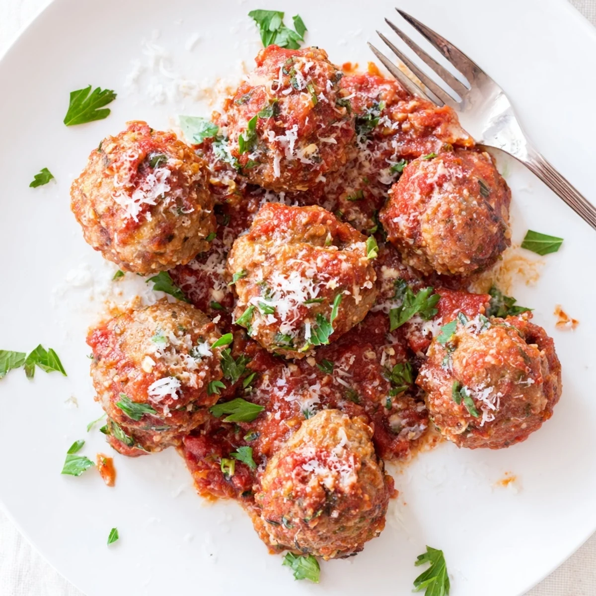 Tender beef and pork authentic Italian meatballs served over spaghetti with grated Parmesan cheese topping