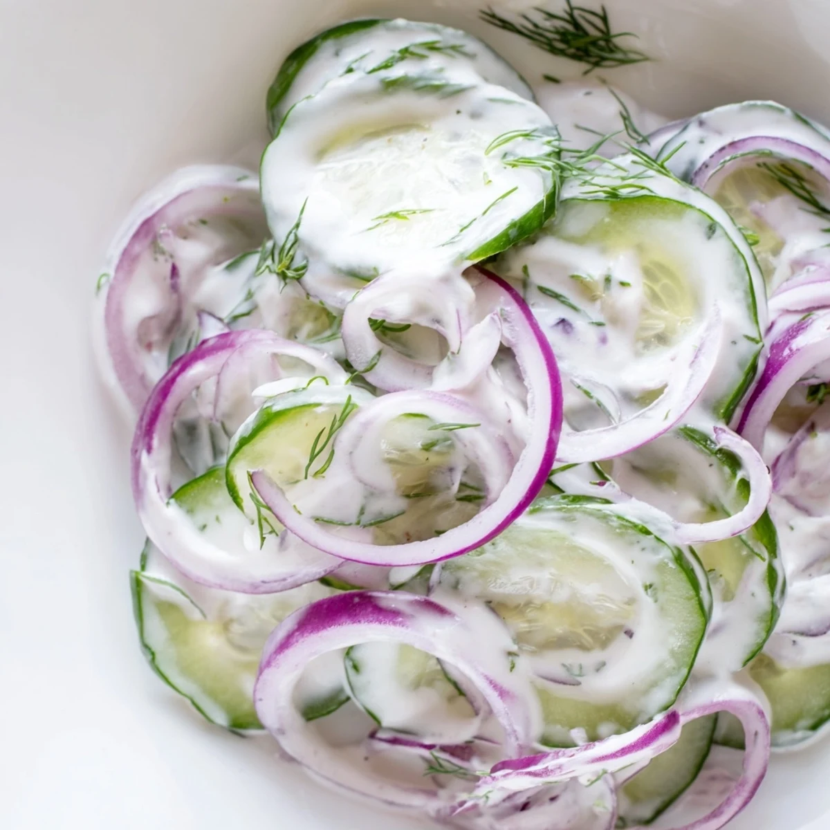 Fresh creamy cucumber salad with crisp sliced cucumbers in a tangy white dressing with dill