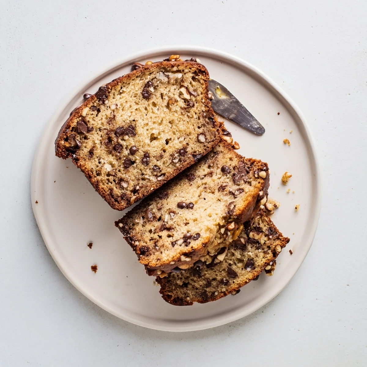 Homemade chocolate chip banana bread with dark chunks peeking through a tender golden-brown crumb