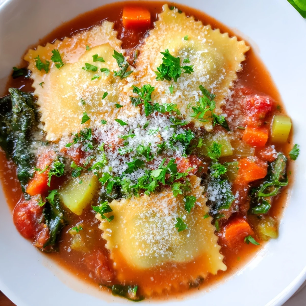 Creamy tomato broth filled with tender cheese ravioli, fresh spinach, and grated Parmesan cheese in this easy Tuscan ravioli soup