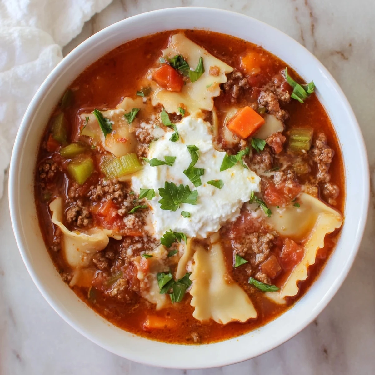 Hearty one-pot Italian lasagna soup featuring tender pasta, savory beef, and melted mozzarella cheese