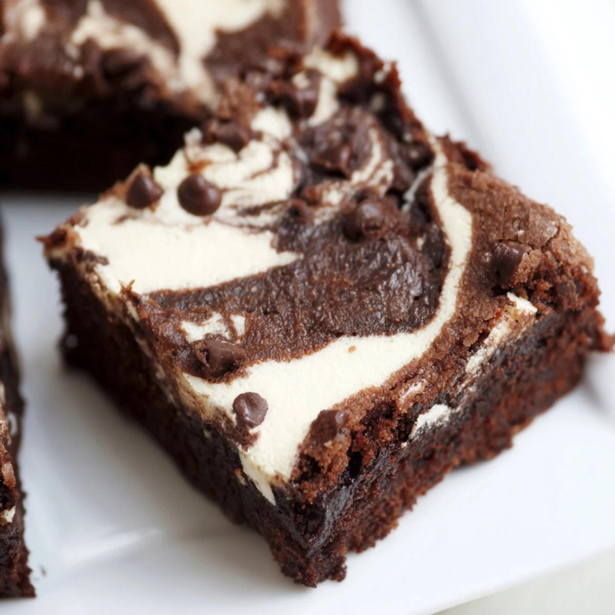 Fudgy cottage cheese brownies featuring a marbled swirl of creamy vanilla cheese topping