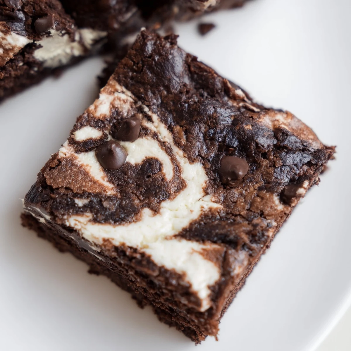 Homemade cottage cheese brownies sliced into squares showing the swirled chocolate and cream cheese layers