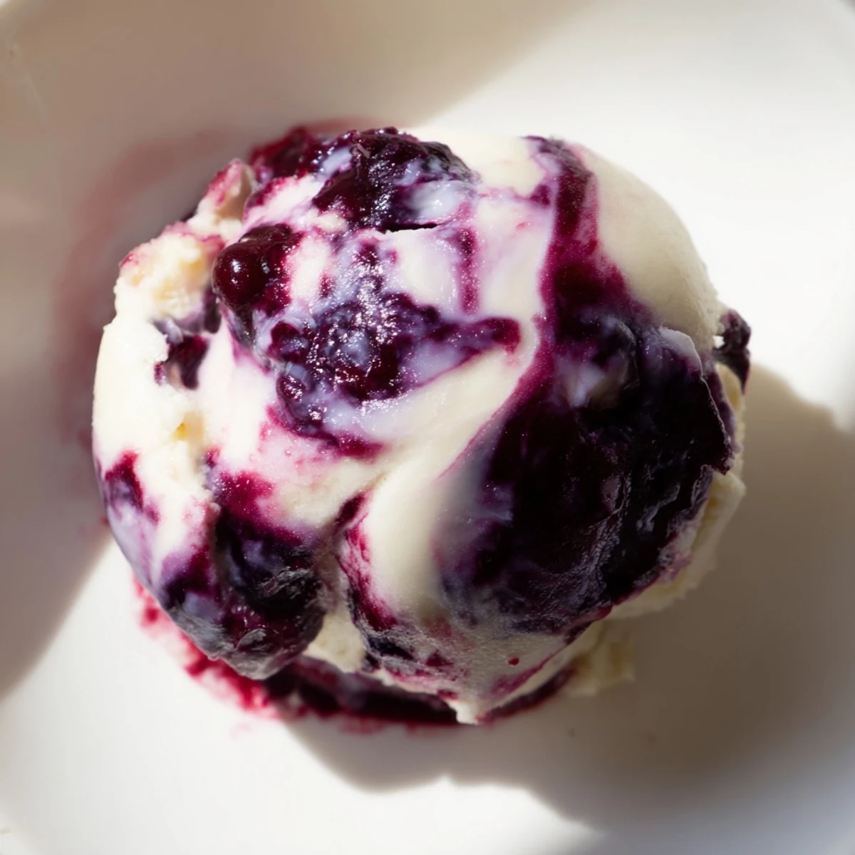 Healthy blueberry swirl yogurt bites served chilled on a wooden board with mint sprigs