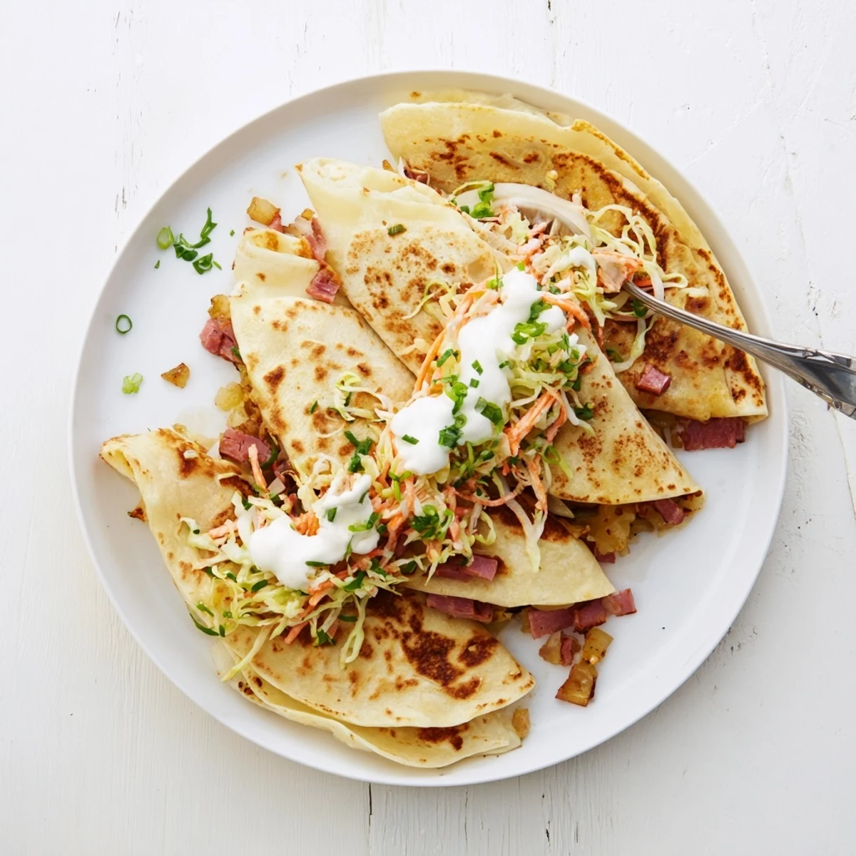Warm flour tortilla filled with tender corned beef, crispy potatoes, and fresh cabbage slaw
