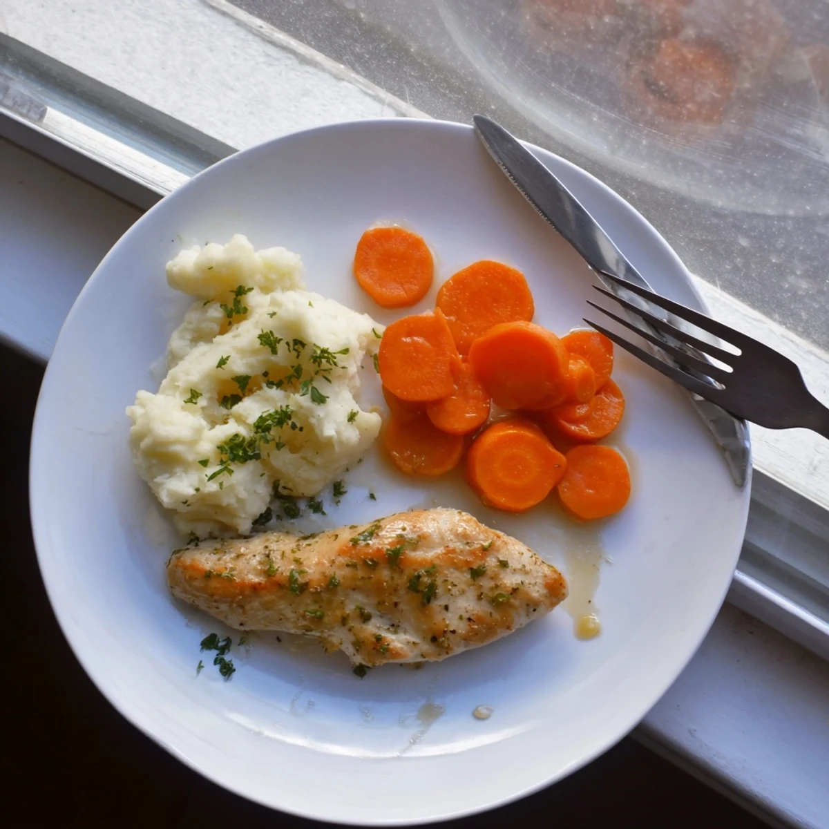Juicy garlic and Italian herb chicken served over smooth mashed potatoes with glazed carrot garnish