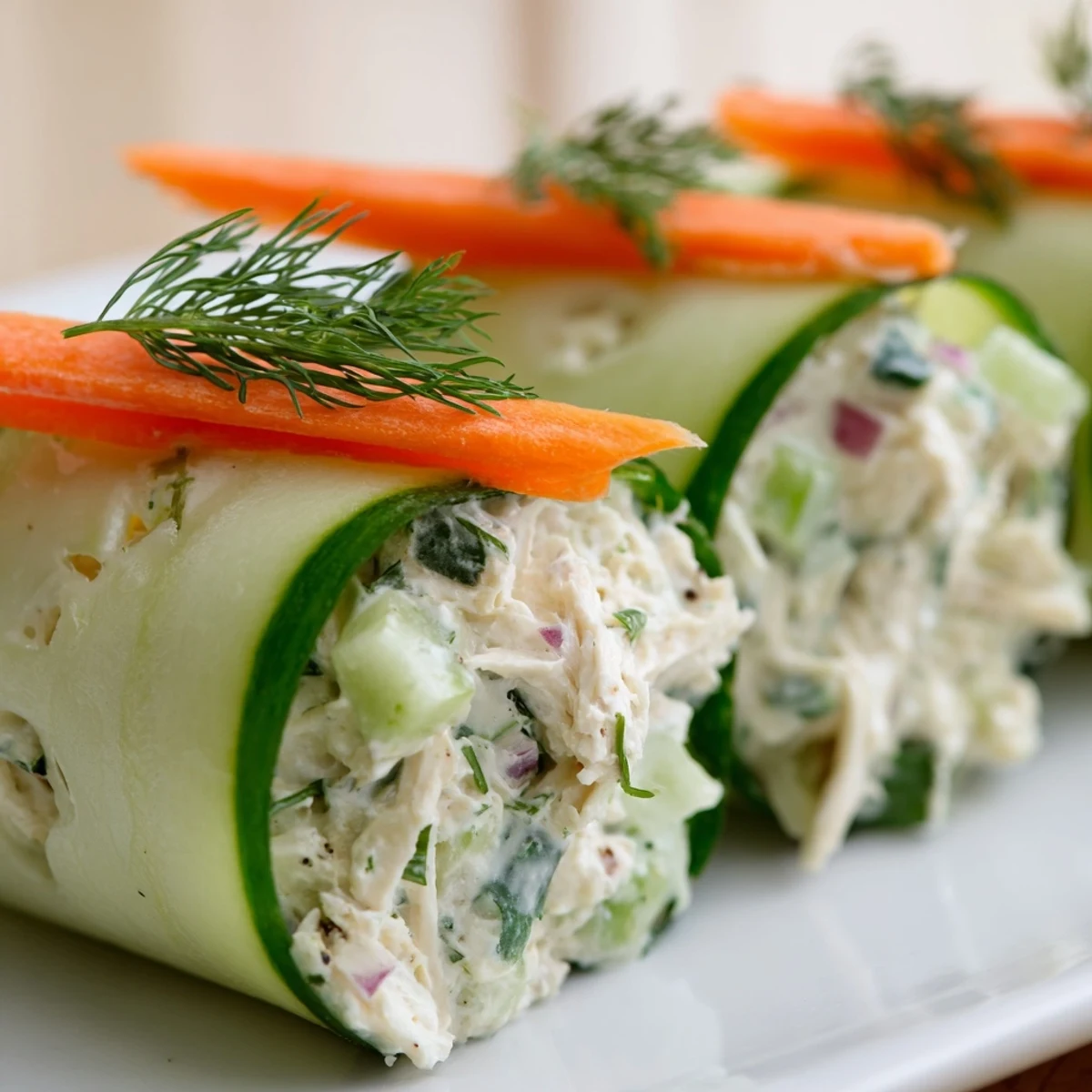 Fresh cucumber ribbon rolled around creamy chicken salad for a light appetizer