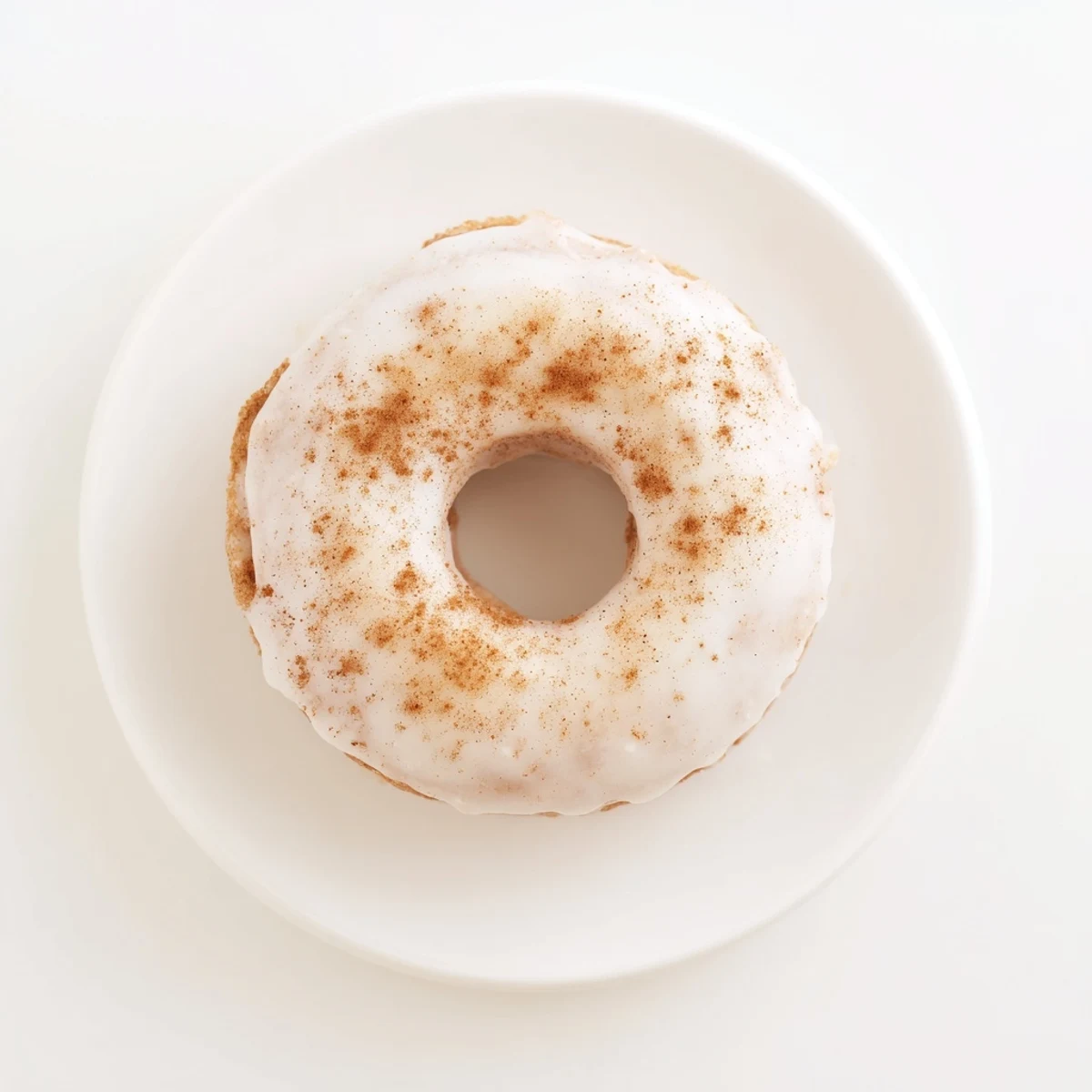 Golden baked Greek yogurt cake donuts topped with sweet vanilla glaze and sprinkles