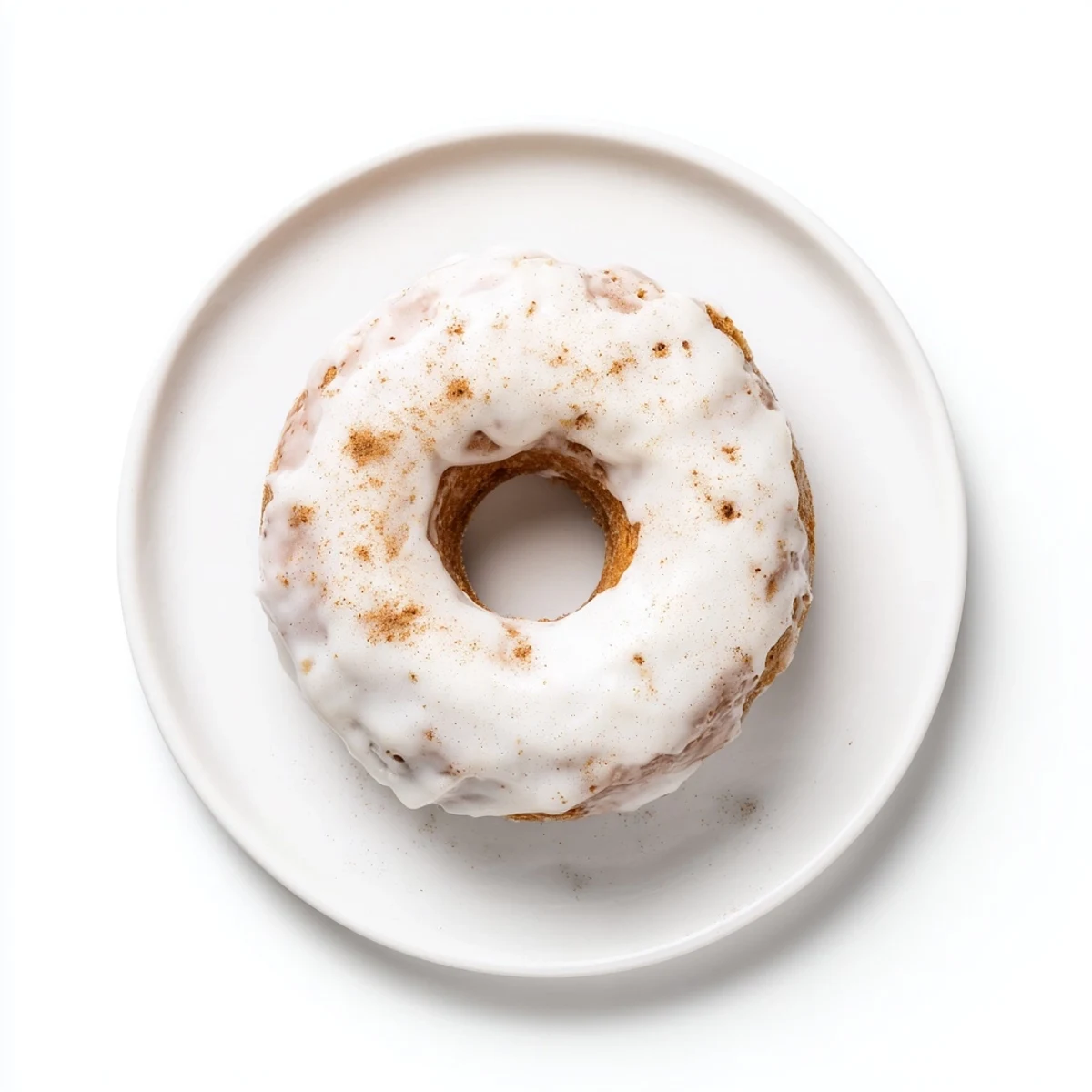 Batch of moist Greek yogurt cake donuts with creamy glaze drizzling down the sides