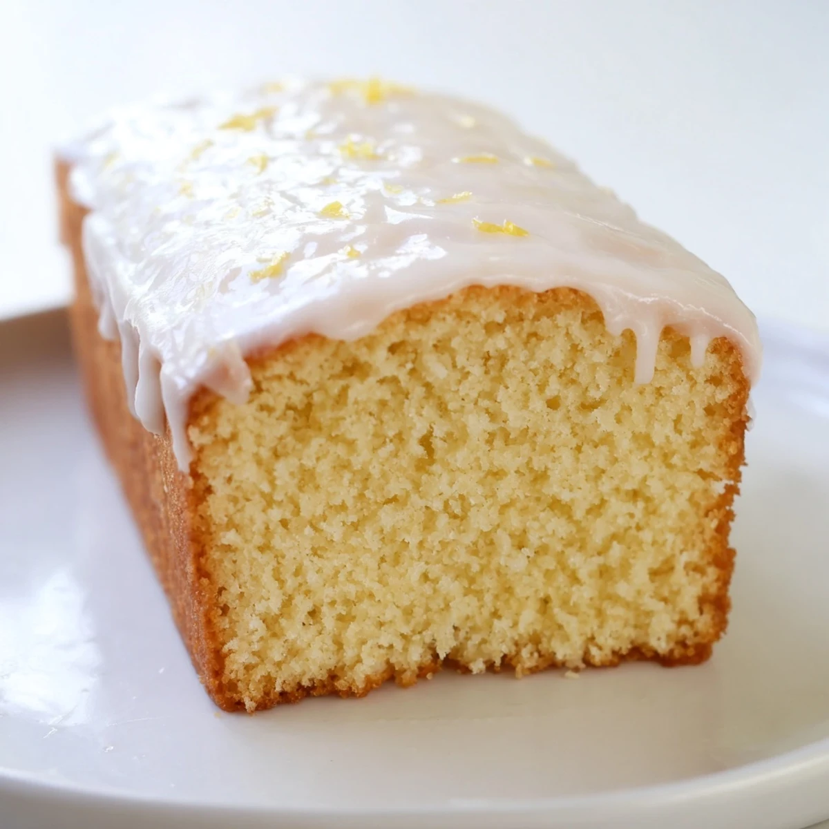 Classic church cake sliced on a vintage plate showcasing its soft fluffy vanilla-infused crumb