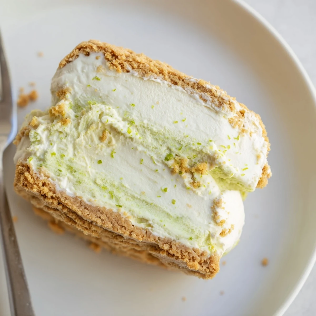 Tart, tangy Key Lime Pie Ice Cream Sandwiches served frozen, rolled in crumbs.