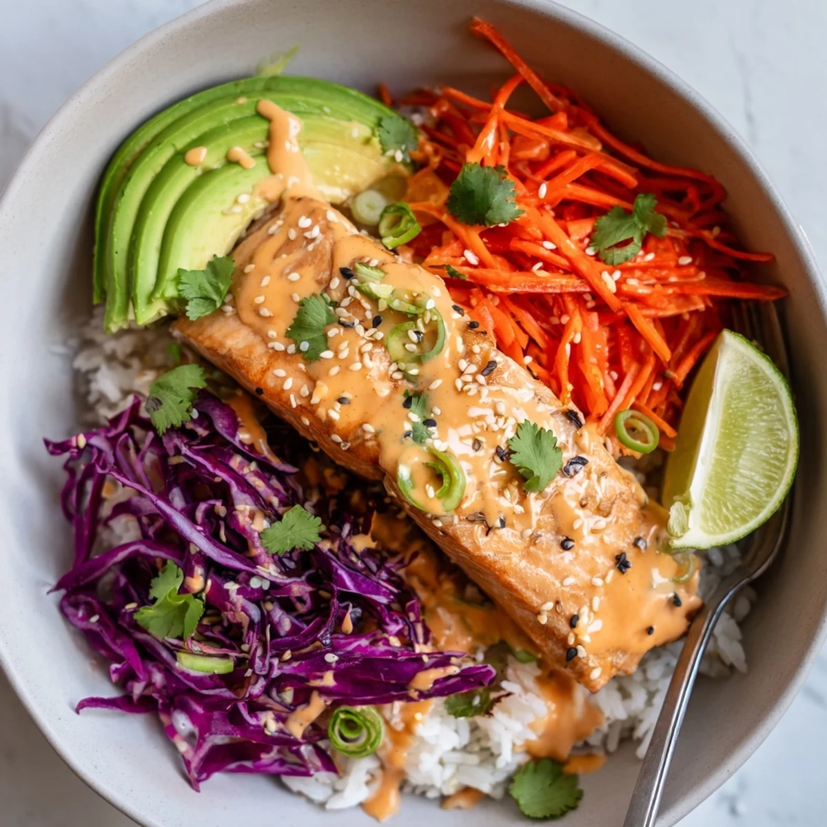 Weeknight Bang Bang Salmon Bowls Recipe served over fluffy jasmine rice, crunchy cabbage
