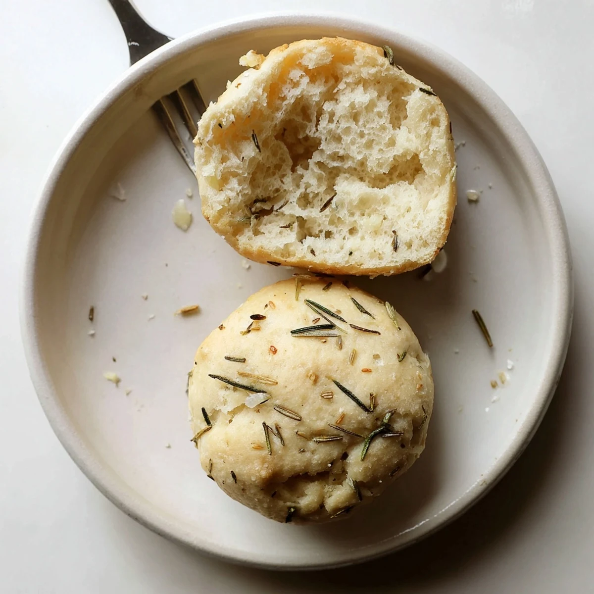 Warm Garlic Rosemary Focaccia Muffins with golden crust and olive oil sheen