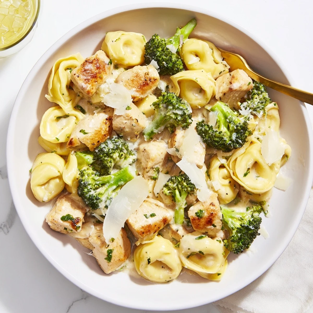 Creamy Garlic Parmesan Tortellini Chicken Broccoli Recipe steaming in skillet, cheese melting  