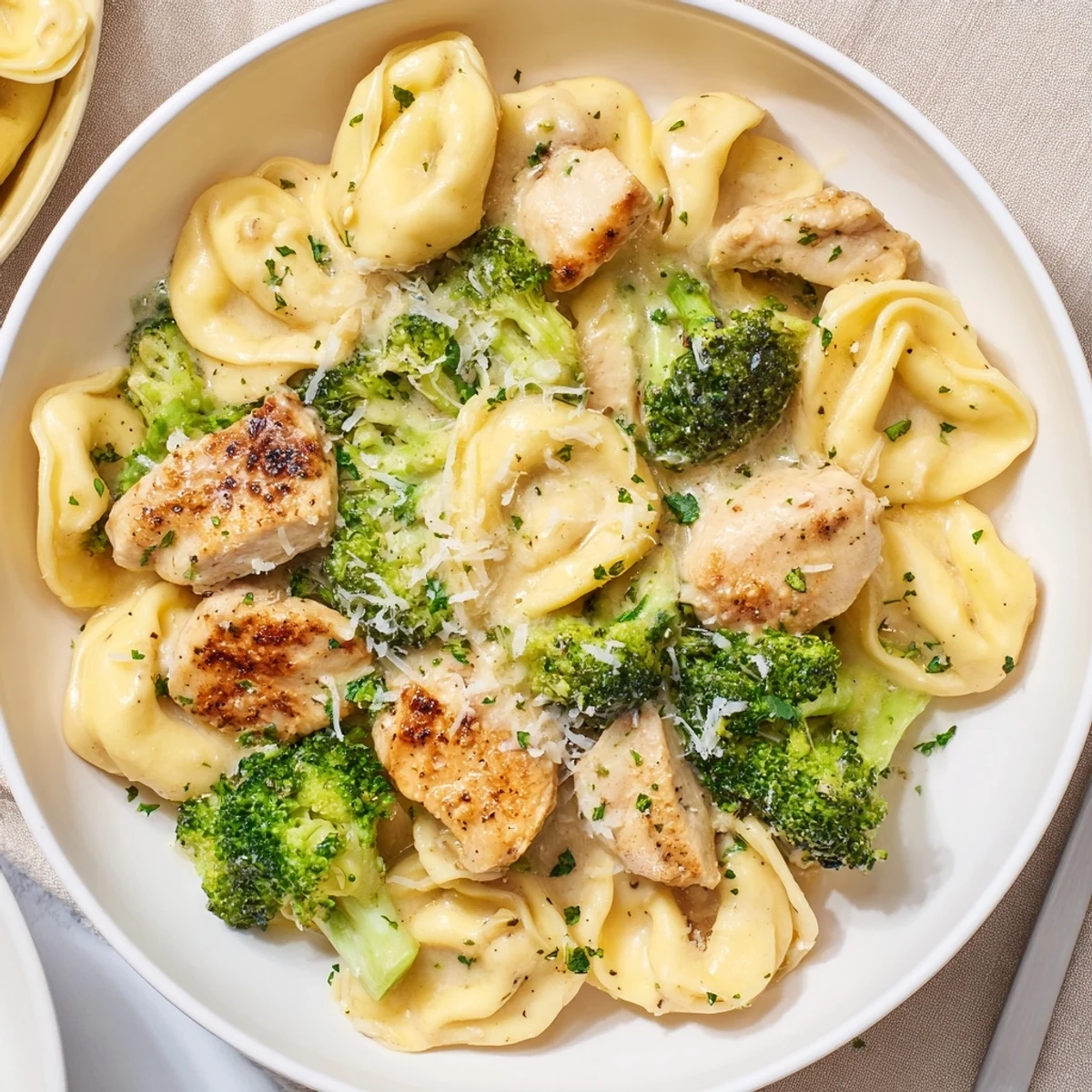 Forkful of cheesy goodness from Creamy Garlic Parmesan Tortellini Chicken Broccoli Recipe, steaming