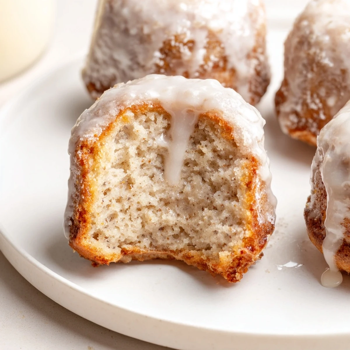 Banana Donuts with golden crust and moist crumb cooling on wire rack
