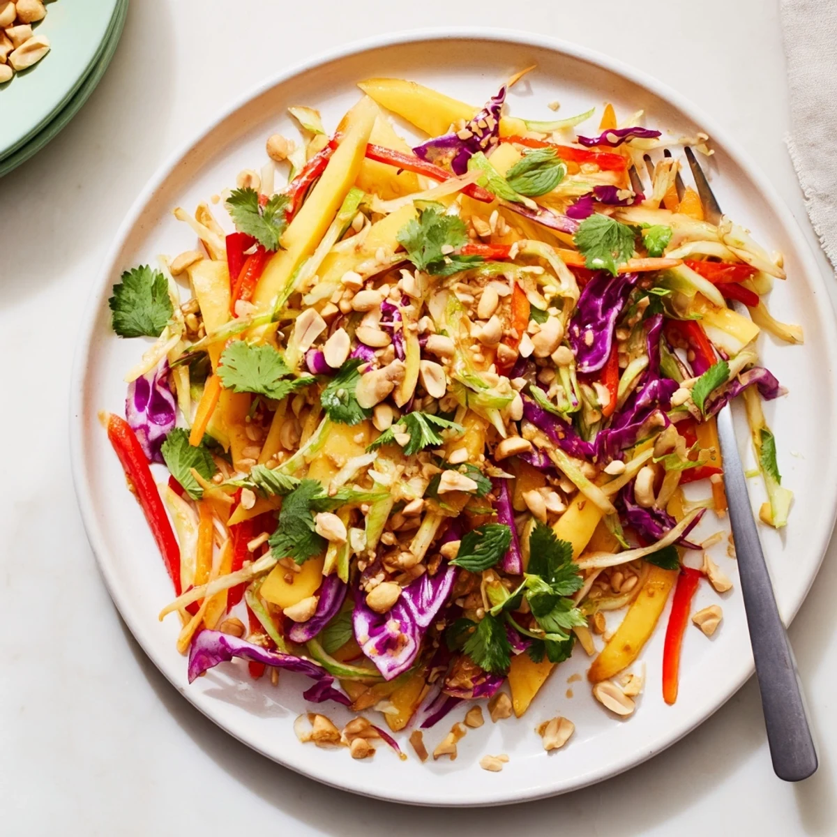 GoldenRefreshing Mango Slaw featuring vibrant julienned mango atop a bed of crisp red cabbage