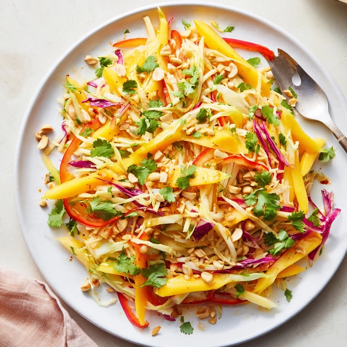 ColorfulRefreshing Mango Slaw bowl displaying crunchy vegetables and sweet mango tossed in zesty lime dressing