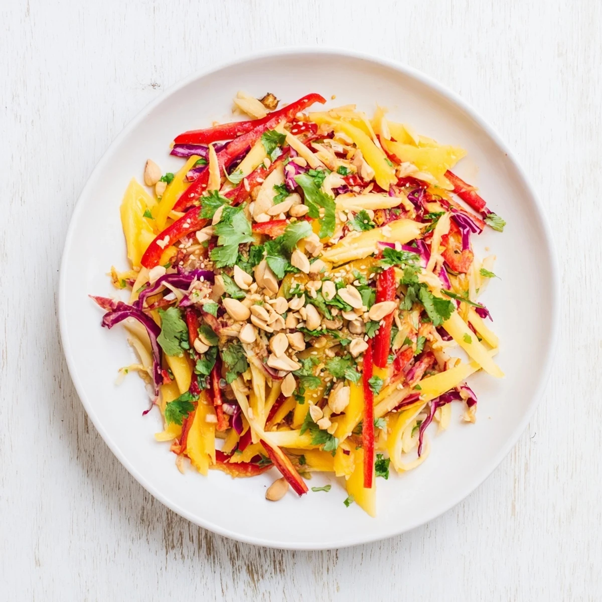 FreshRefreshing Mango Slaw sprinkled with toasted sesame seeds and chopped peanuts for irresistible summer crunch