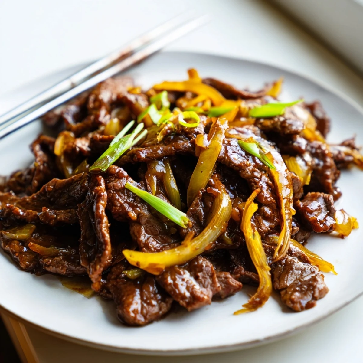 Golden crispy beef strips tossed with caramelized onions in a rich savory sauce