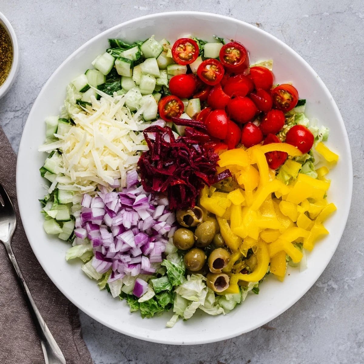 A bowl of Zesty Italian Chopped Salad With Parmesan And Peppers, ready to serve