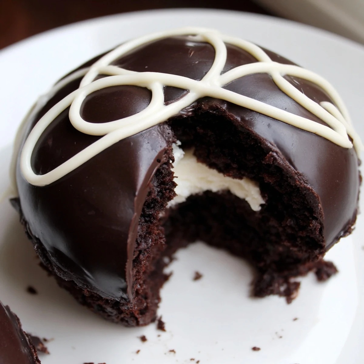 Homemade Hostess Cupcakes with glossy chocolate ganache and fluffy marshmallow filling