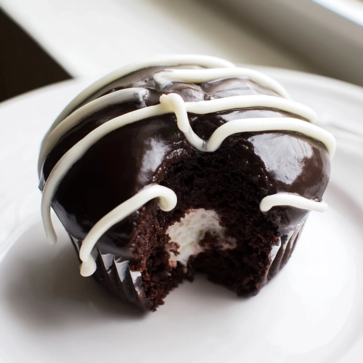 Creamy-filled Homemade Hostess Cupcakes featuring rich chocolate cake and classic vanilla piping