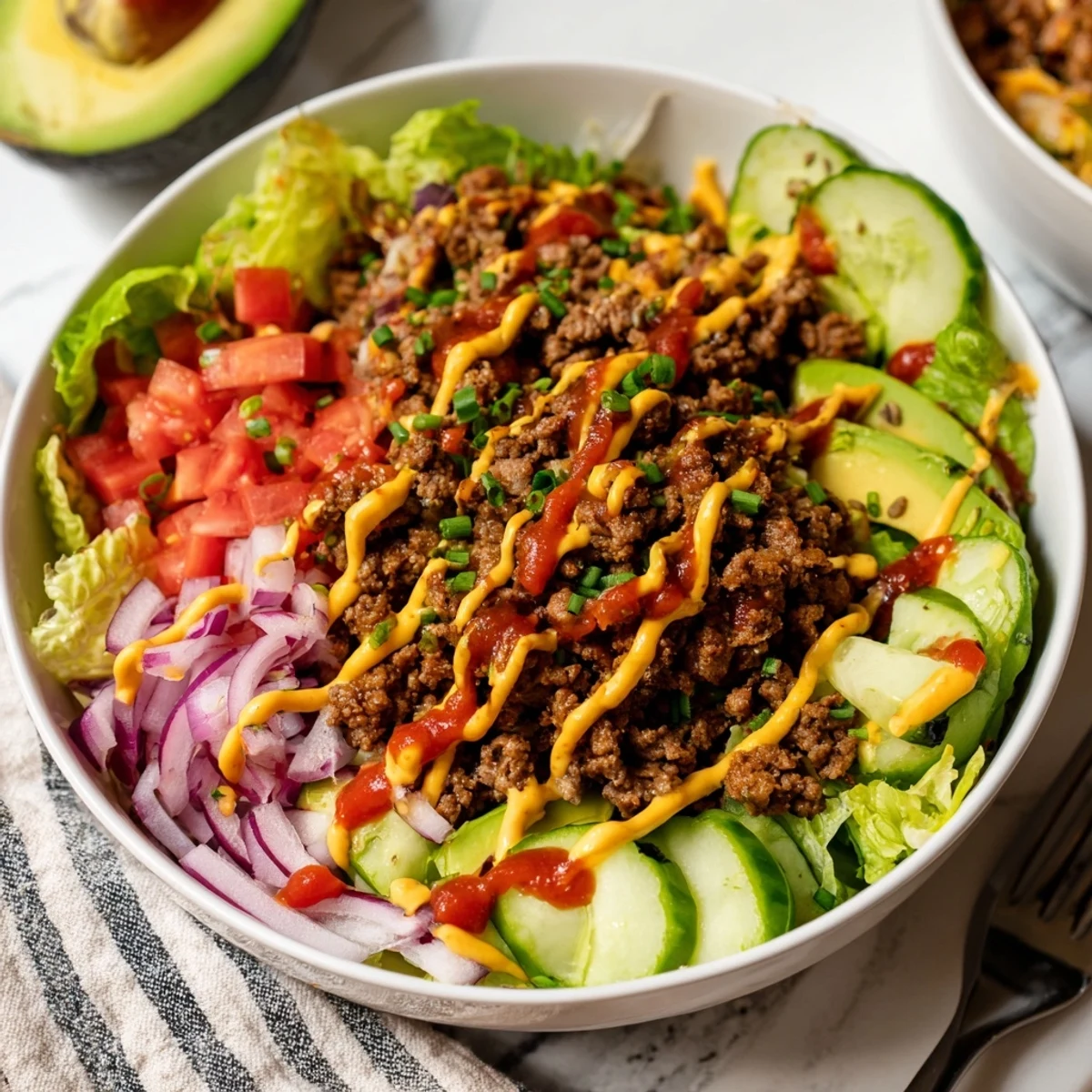 Sliced avocado and cheddar garnish this easy gluten-free burger bowl recipe.