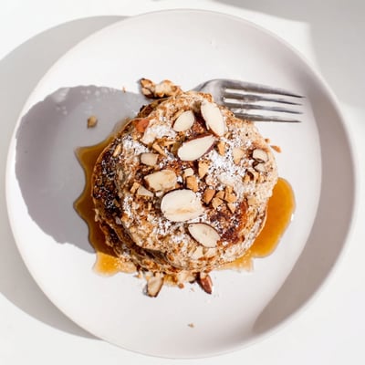 Warm Almond Croissant Protein Pancakes with toasted almonds and buttery croissant crunch
